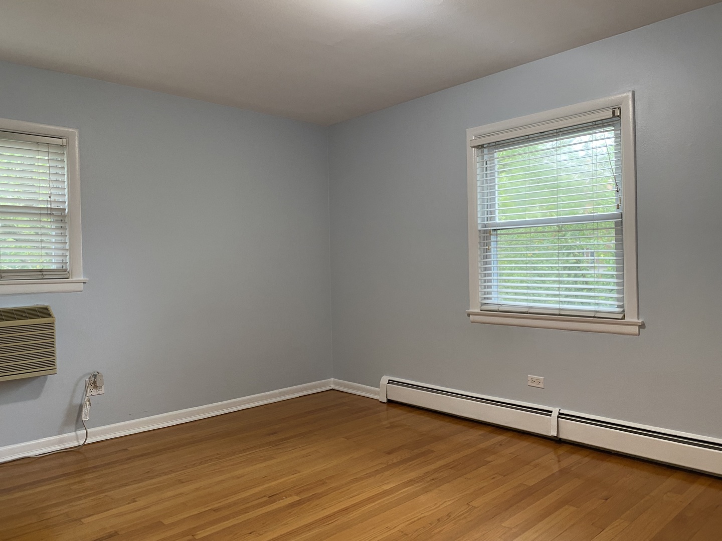 2145 Ridge Avenue, Unit 3A Evanston, IL 60201 - Photo 2 of 3 a view of an empty room with wooden floor and a window