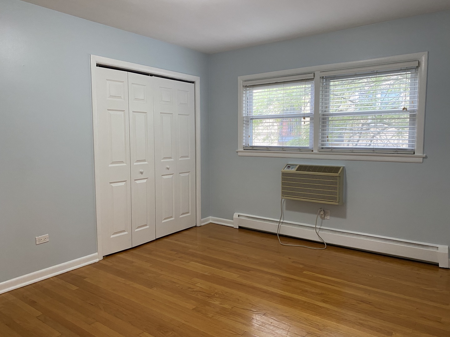 2145 Ridge Avenue, Unit 3A Evanston, IL 60201 - Photo 3 of 3 an empty room with wooden floor and windows