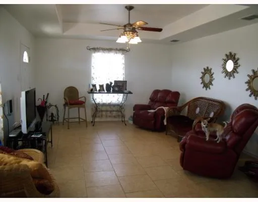 a living room with furniture a chandelier and a window