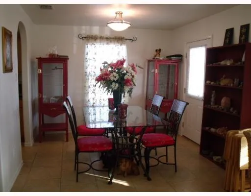 a view of a dining room with furniture and a potted plant