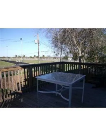 a view of a balcony with furniture and wooden floor