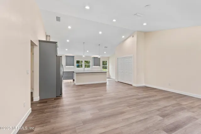a view of kitchen entryway with wooden floor