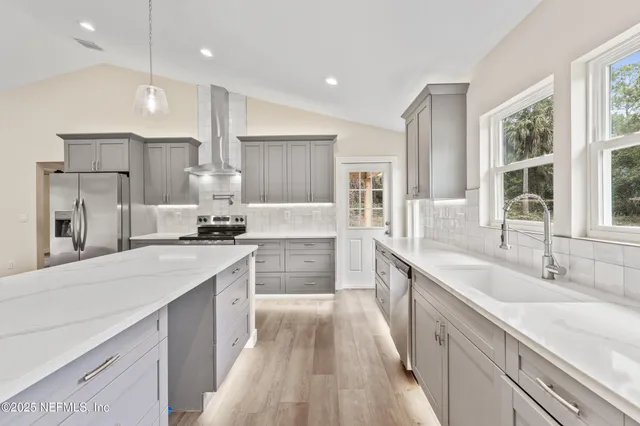 a large kitchen with stainless steel appliances kitchen island granite countertop a large counter top a sink stainless steel appliances and cabinets