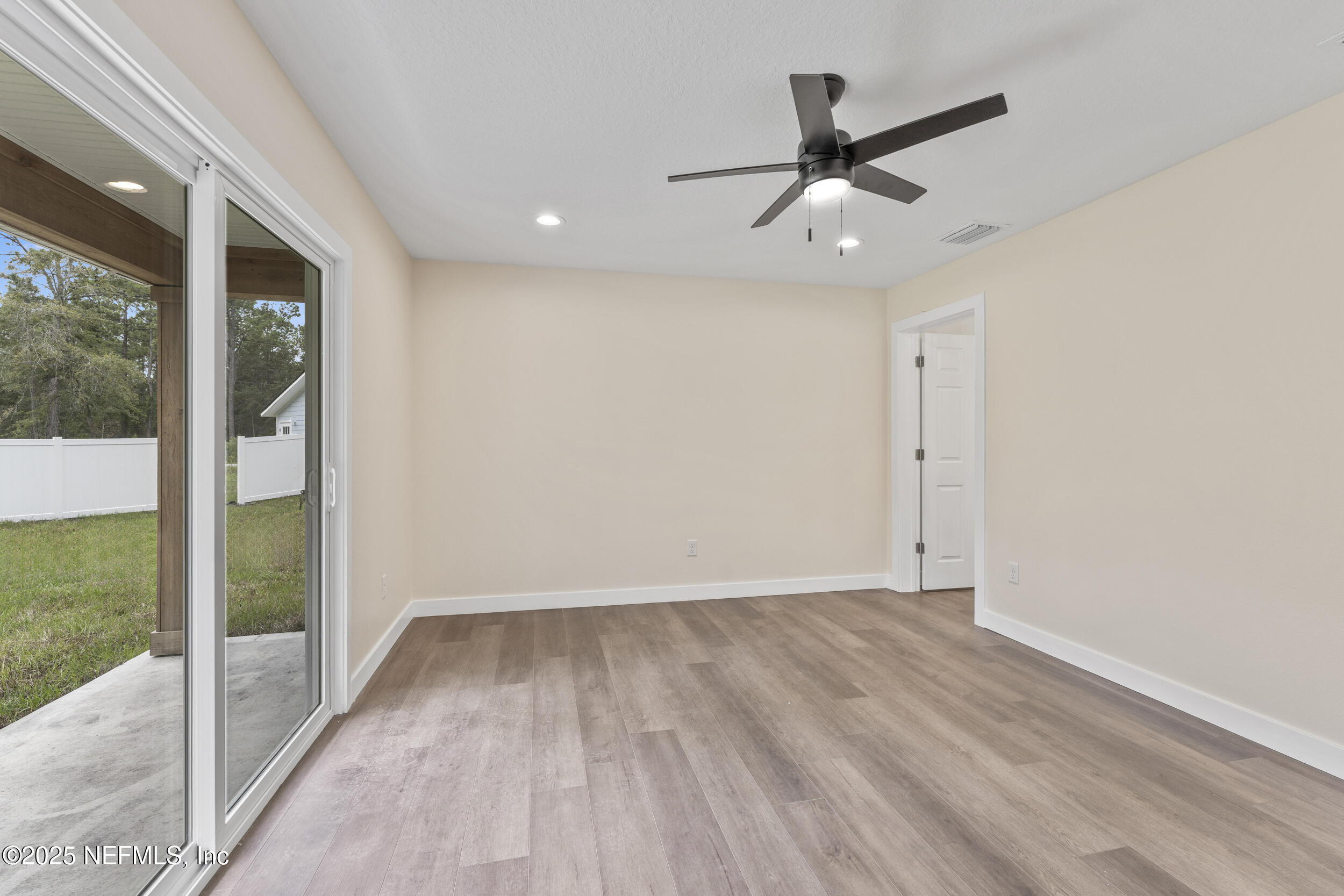 105 Southeast 3rd Street Georgetown, FL 32139 - Photo 18 of 29 an empty room with wooden floor and a ceiling fan