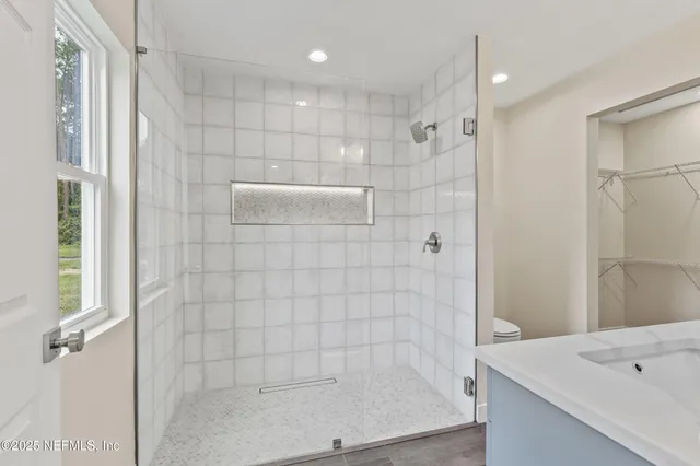 a bathroom with a shower and a sink