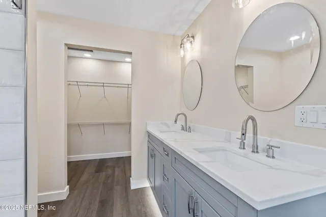a bathroom with a double vanity sink and a mirror