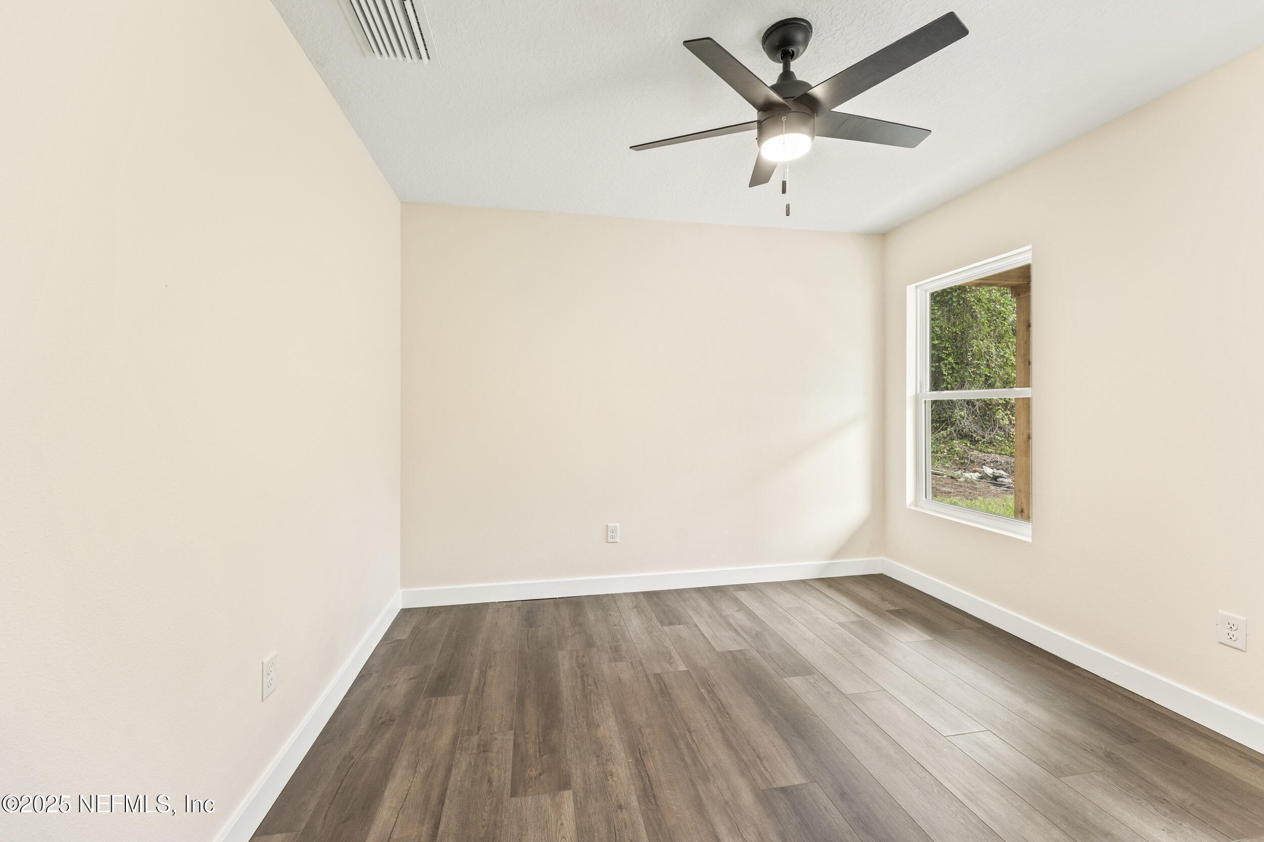 105 Southeast 3rd Street Georgetown, FL 32139 - Photo 23 of 29 an empty room with wooden floor and windows