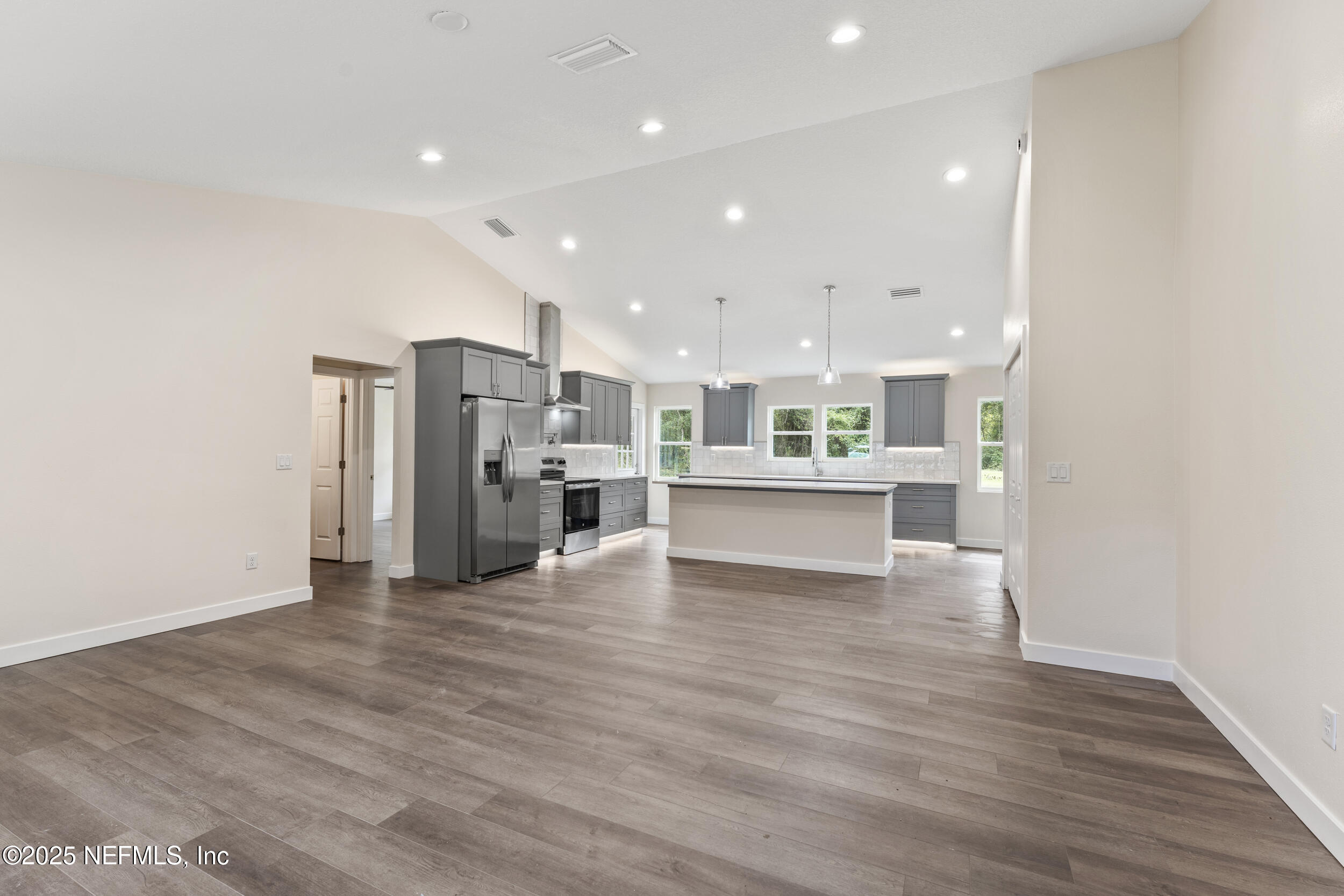 105 Southeast 3rd Street Georgetown, FL 32139 - Photo 6 of 29 a view of kitchen with kitchen island refrigerator wooden floor and center island