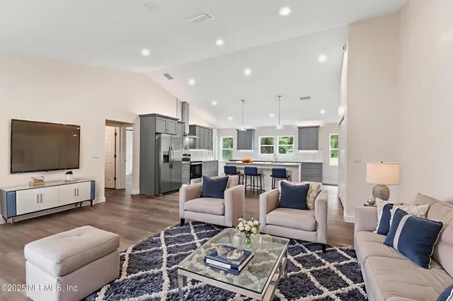 a living room with furniture and a flat screen tv