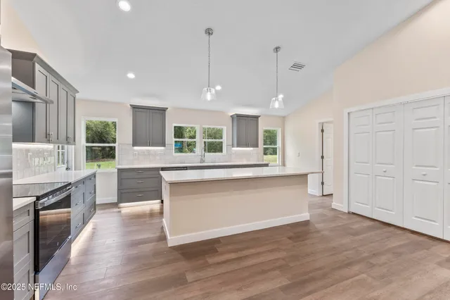 a kitchen with counter top space and stainless steel appliances