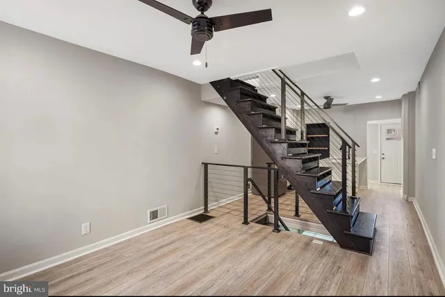 a view of entryway and hall with wooden floor