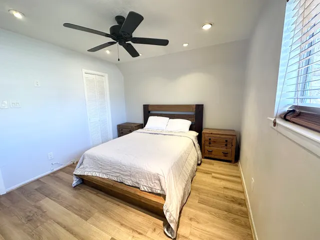 a bedroom with a bed and a window