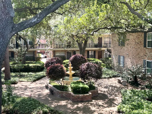 a front view of a house with a yard and a garden