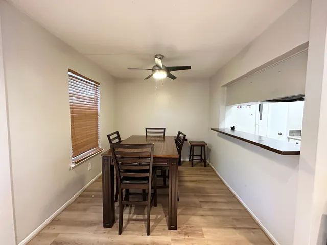 a view of a dining room with furniture and a window