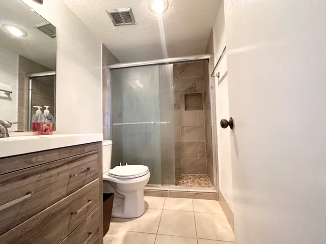 a bathroom with a sink toilet and shower
