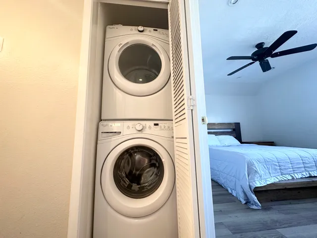 a bedroom with a washer and dryer