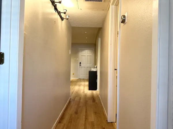 a view of a bathroom from a hallway
