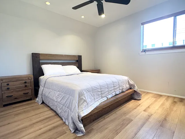 a bedroom with a bed and a window