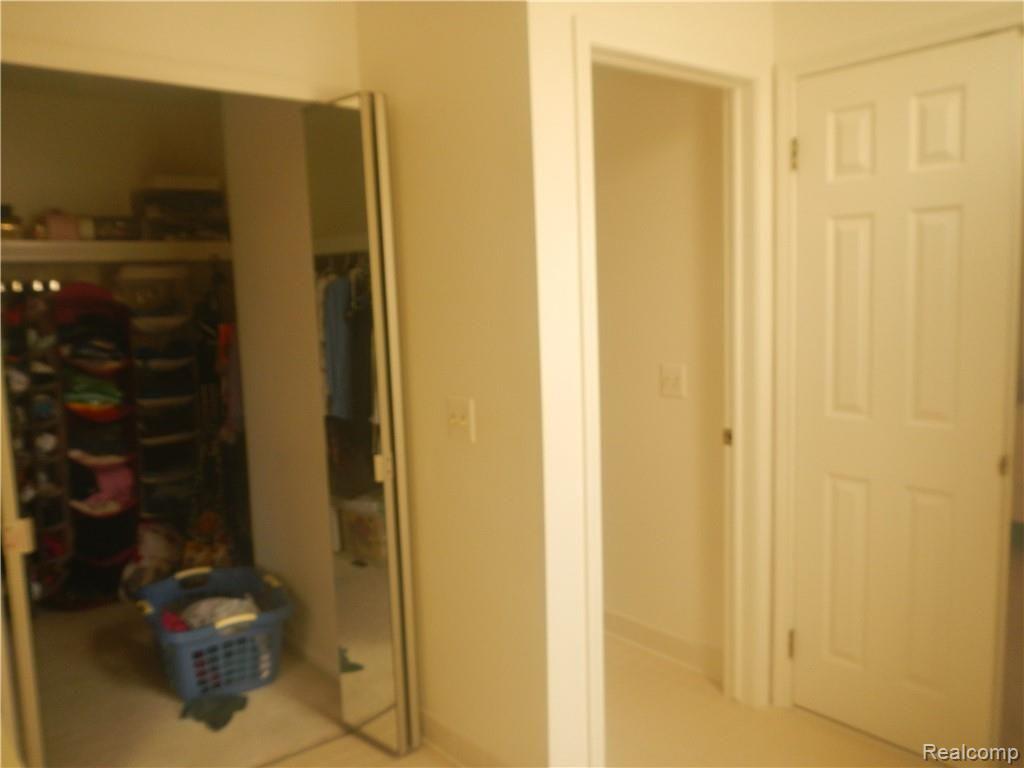 629 Summit Ridge Drive, Unit 13 Milford, MI 48381 - Photo 37 of 59 WALK IN CLOSET AND ENCLOSED TOILET AREA.