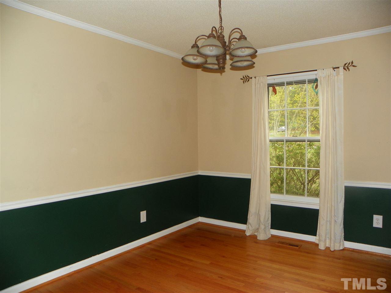 5115 McCormick Road Durham, NC 27713 - Photo 2 of 11 a view of an empty room with wooden floor and a window