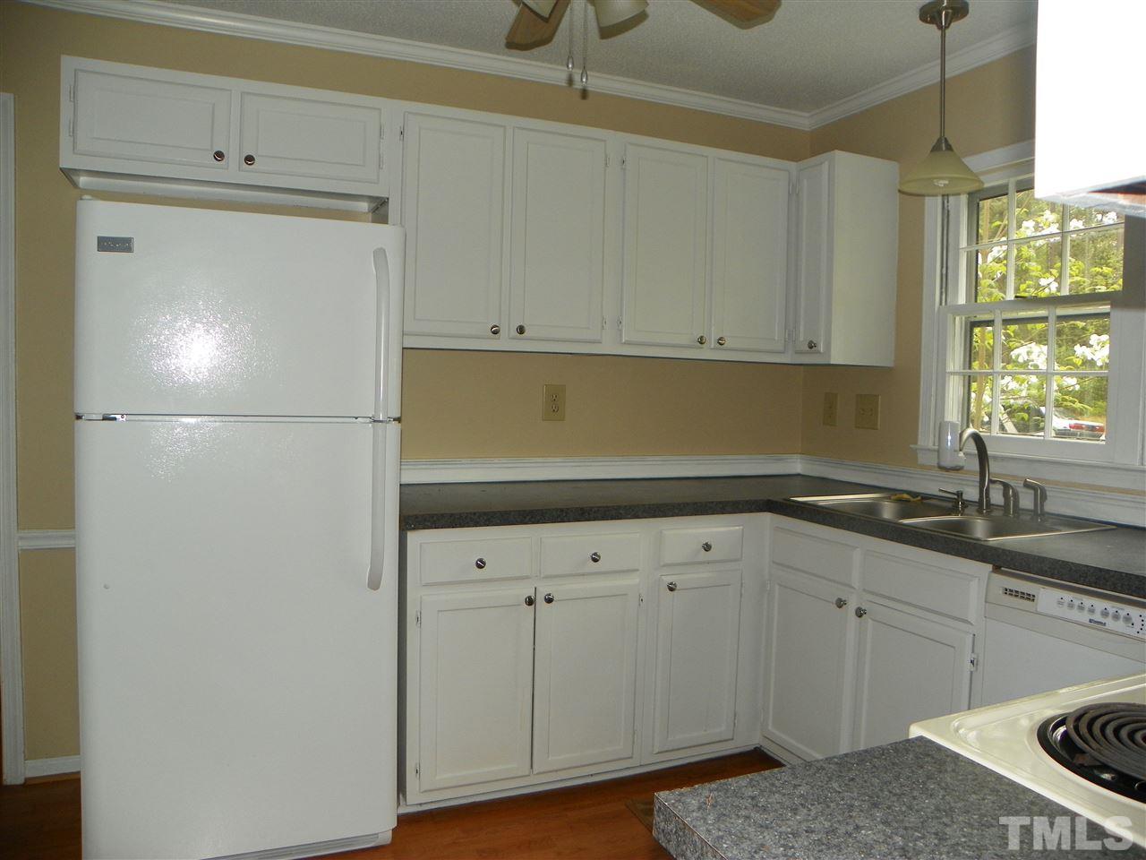 5115 McCormick Road Durham, NC 27713 - Photo 3 of 11 a kitchen with a sink and cabinets