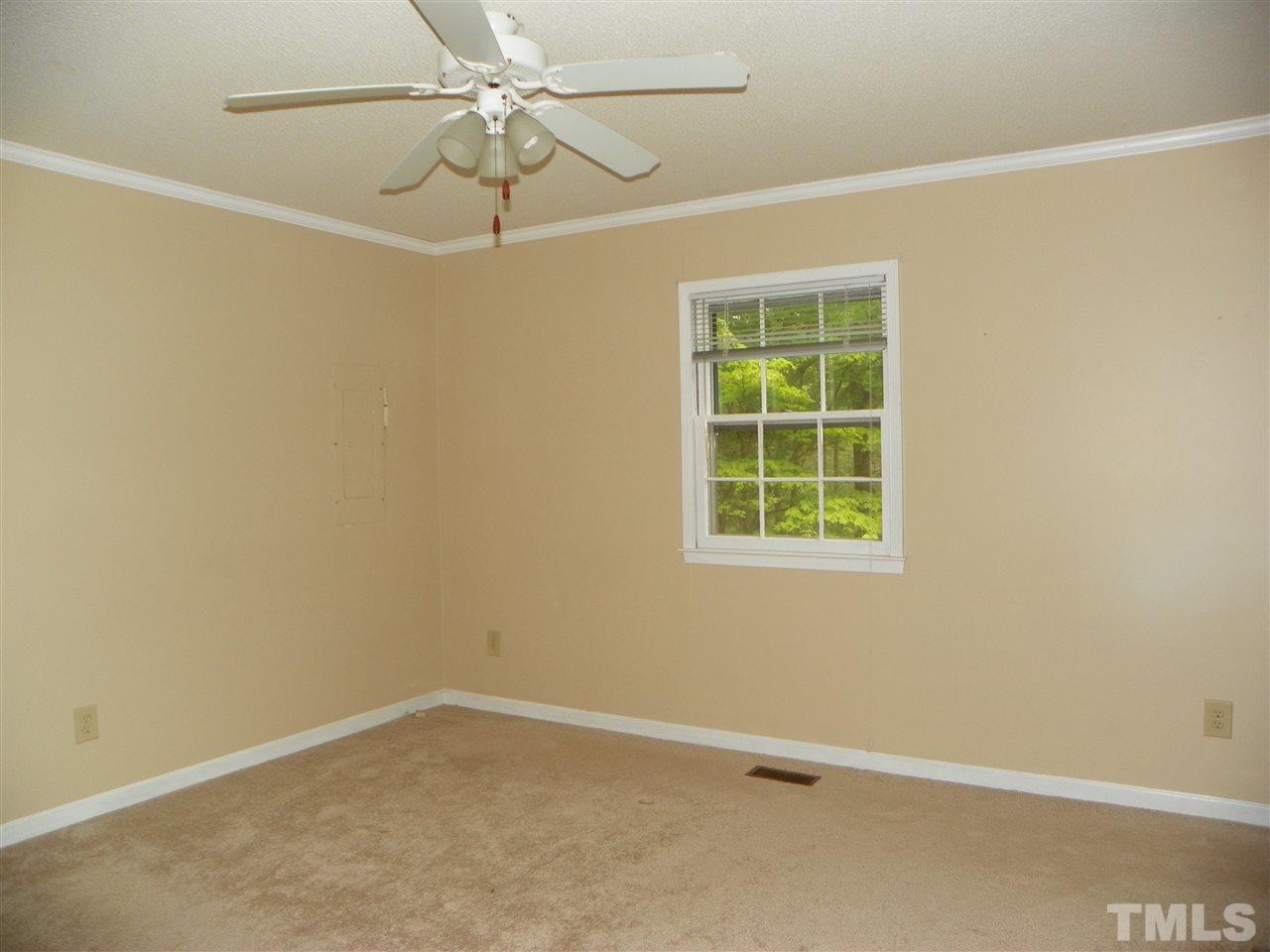5115 McCormick Road Durham, NC 27713 - Photo 8 of 11 an empty room with a window and a fan