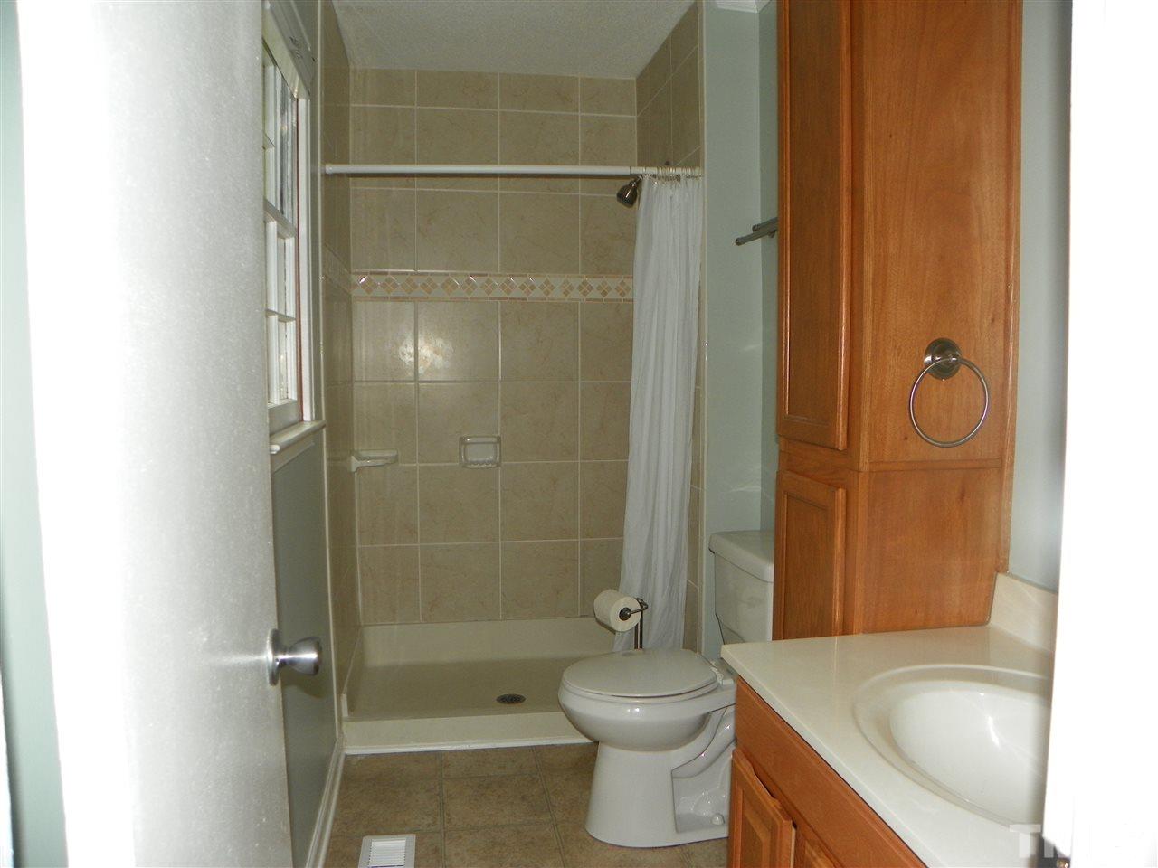 5115 McCormick Road Durham, NC 27713 - Photo 9 of 11 a bathroom with a shower and a toilet