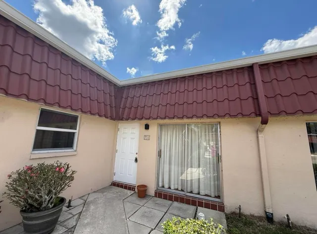 a room with painting on the wall and a potted plant