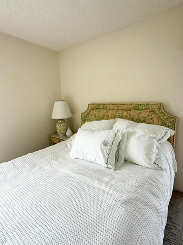 a bedroom with a bed and a night stand