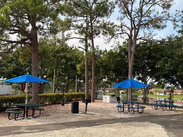 a patio with a table and chairs under an umbrella