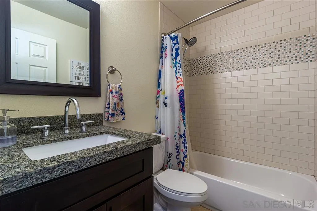8648 Almond Road Lakeside, CA 92040 - Photo 11 of 15 a bathroom with a granite countertop sink toilet and shower