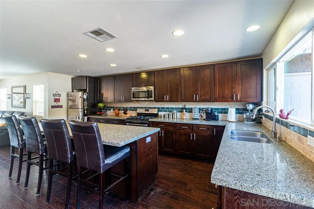 8648 Almond Road Lakeside, CA 92040 - Photo 5 of 15 a large kitchen with lots of table and chairs