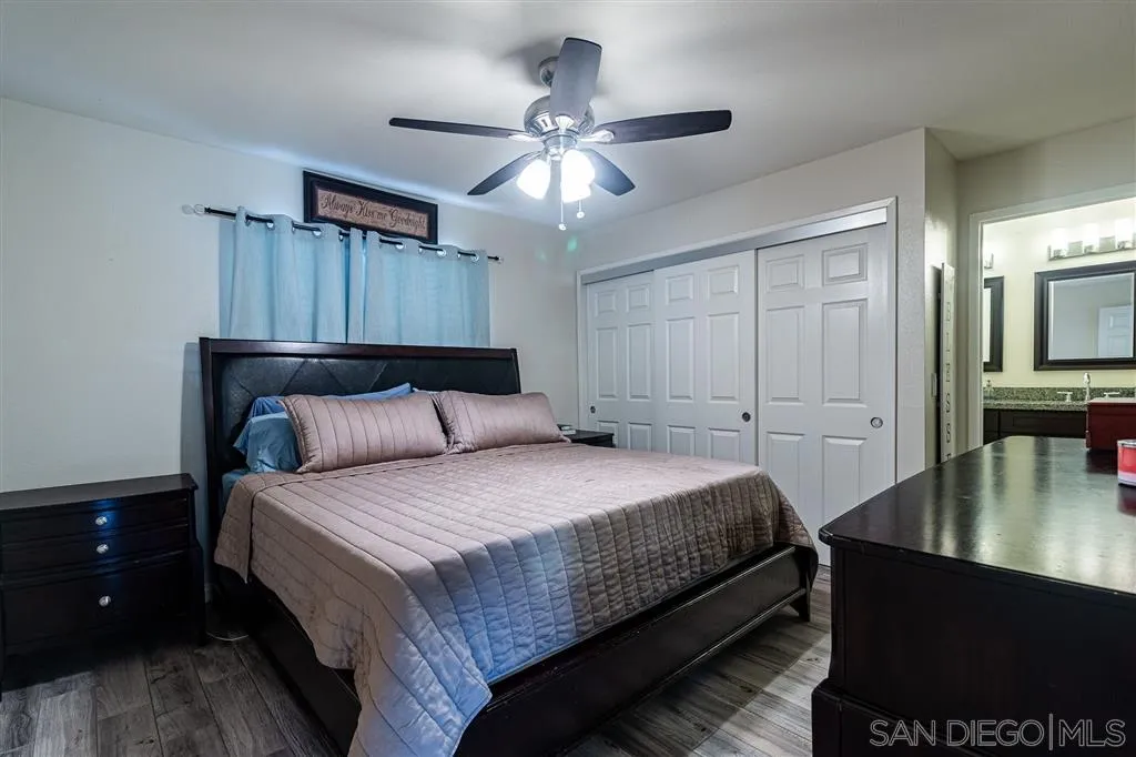 8648 Almond Road Lakeside, CA 92040 - Photo 7 of 15 a bedroom with a bed and a chandelier