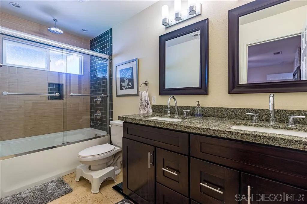 8648 Almond Road Lakeside, CA 92040 - Photo 8 of 15 a bathroom with a granite countertop toilet sink and mirror
