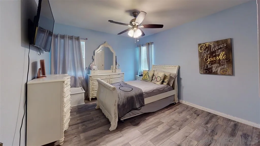 8648 Almond Road Lakeside, CA 92040 - Photo 9 of 15 a spacious bedroom with a bed and a flat screen tv