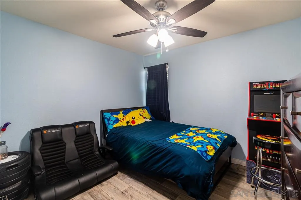 8648 Almond Road Lakeside, CA 92040 - Photo 10 of 15 a bedroom with a bed and a chandelier