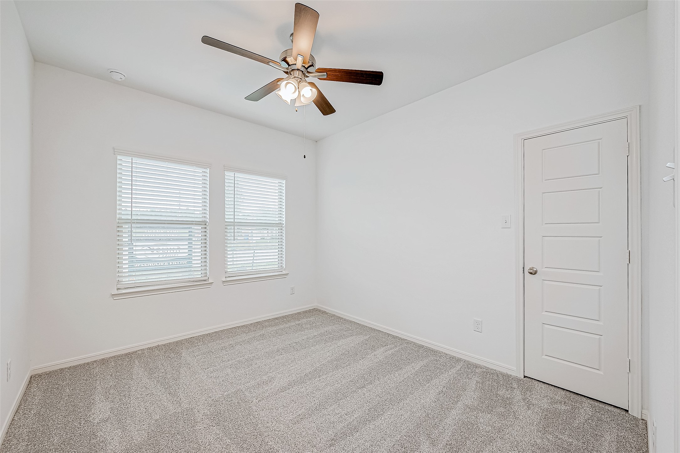 15941 Cy Young Court Splendora, TX 77372 - Photo 18 of 37 an empty room with a chandelier fan and windows