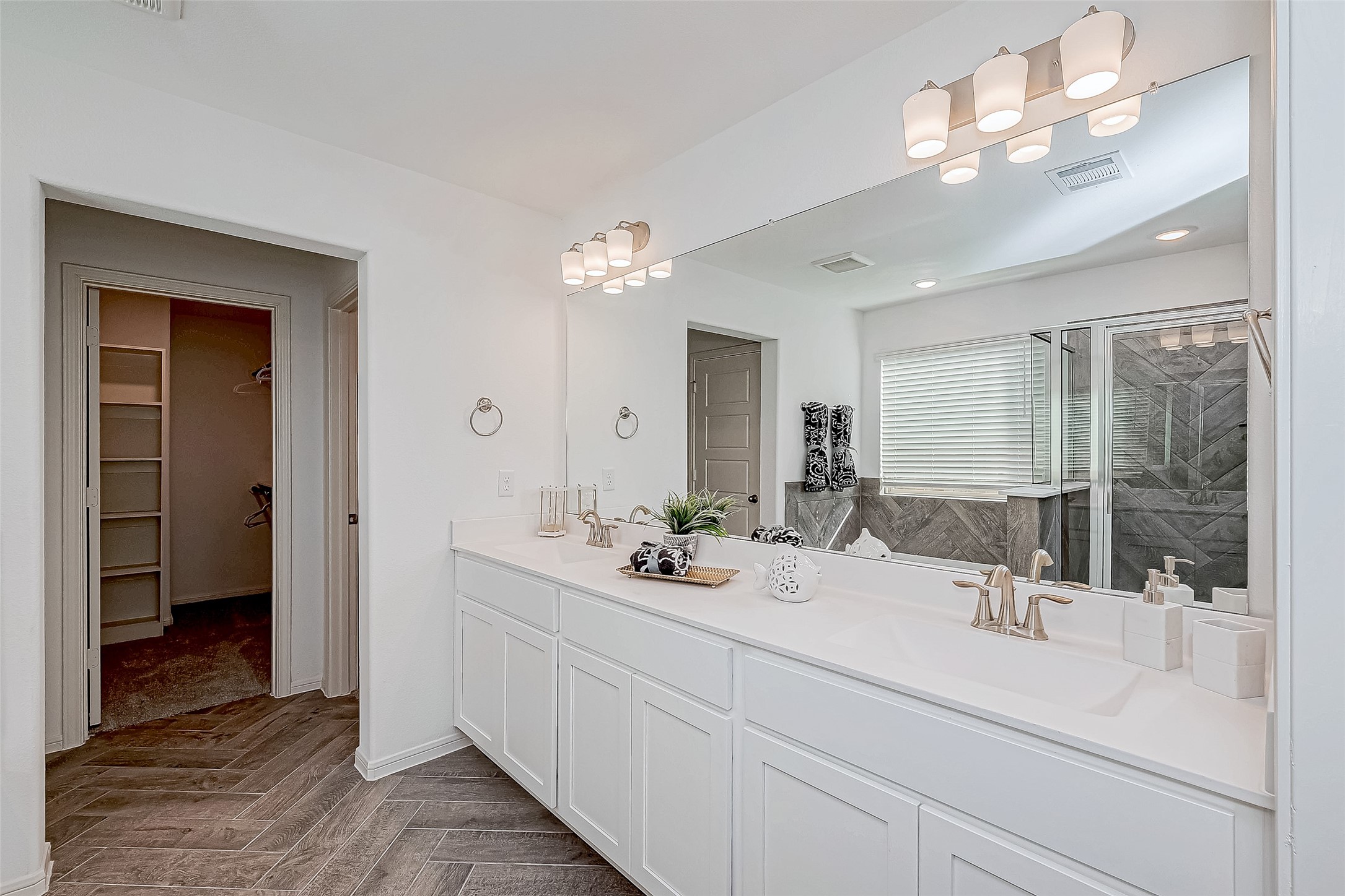 15941 Cy Young Court Splendora, TX 77372 - Photo 24 of 37 a bathroom with a sink a large mirror and vanity