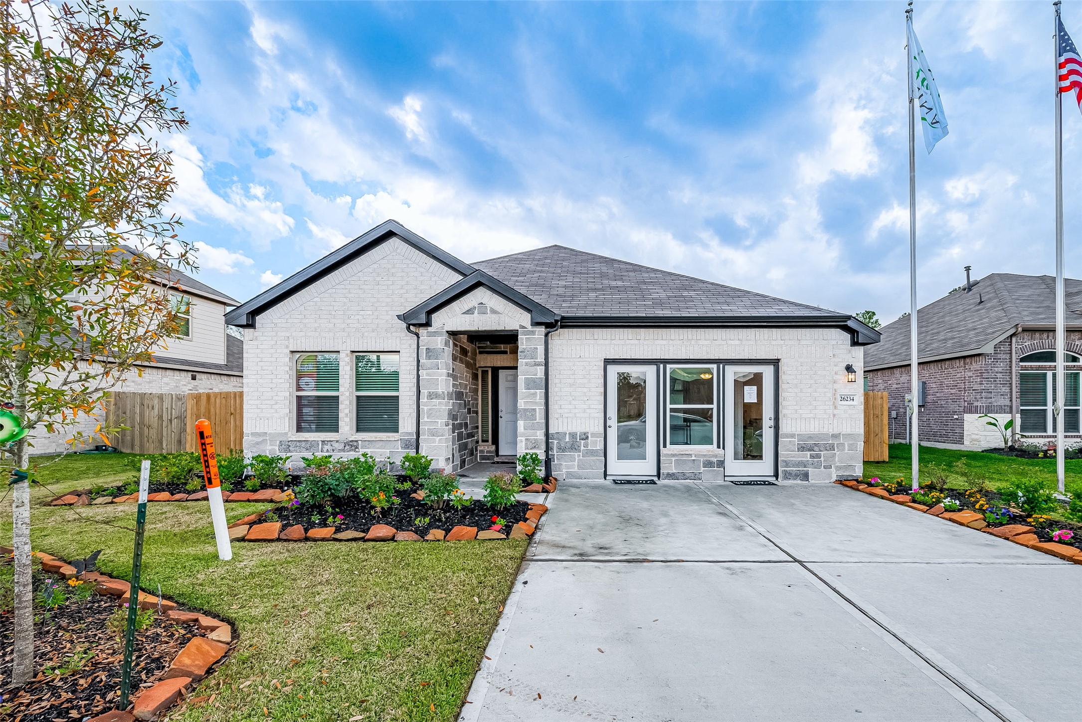15941 Cy Young Court Splendora, TX 77372 - Photo 3 of 37 a front view of a house with a yard and potted plants