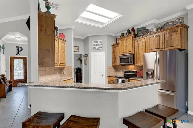 a kitchen with a refrigerator and a sink
