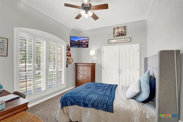 a bedroom with a bed and a window