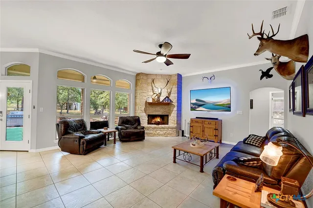 a living room with furniture a fireplace and a large window