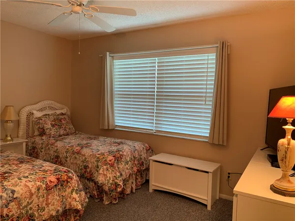 a bedroom with two beds and painted walls