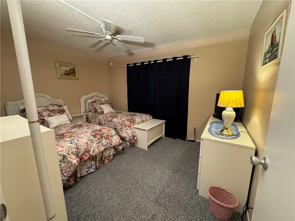 a bedroom with bed and cabinets