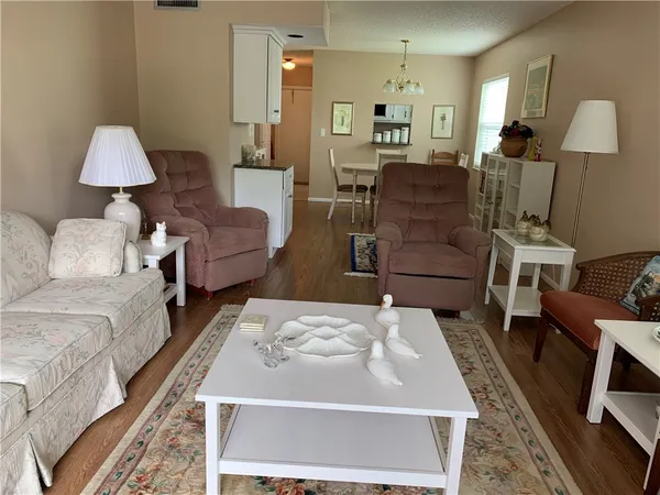 a living room with furniture and a lamp