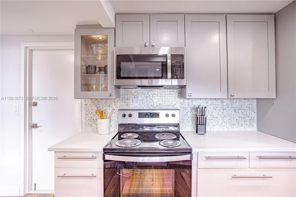 a kitchen with a stove and a microwave