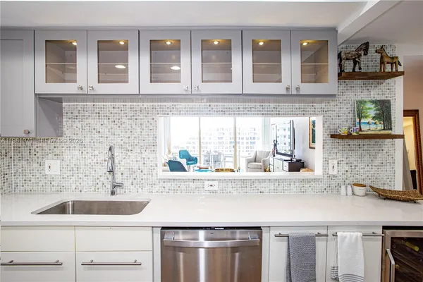 a kitchen with stainless steel appliances granite countertop a sink and a wooden cabinets