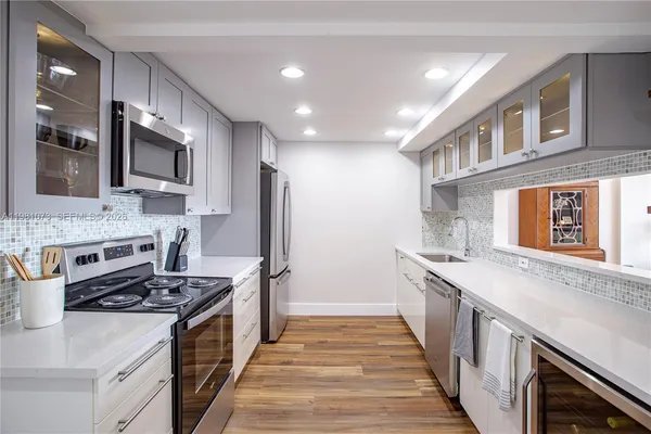 a kitchen with stainless steel appliances granite countertop a stove and a refrigerator