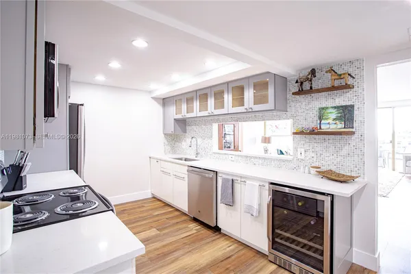 a kitchen with stainless steel appliances a sink stove and refrigerator