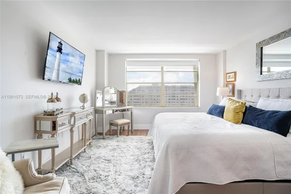 a bedroom with a large bed and a window